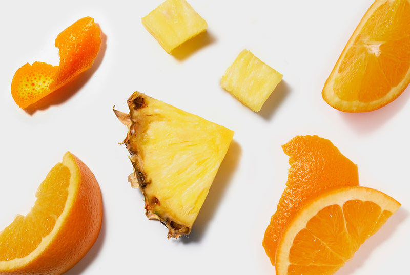 Pineapple and Orange slices on a white background