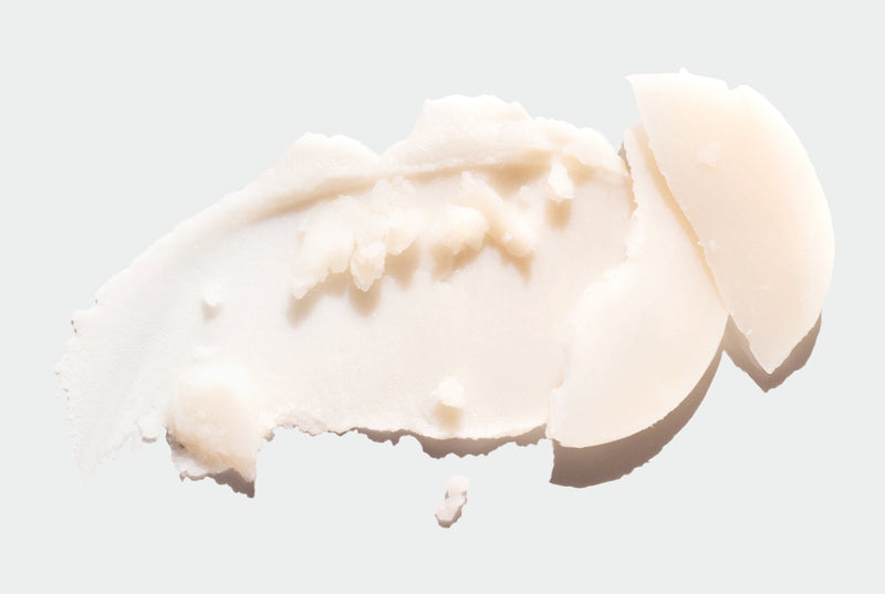 Close-up of a scoop of beige deodorant on a light gray background
